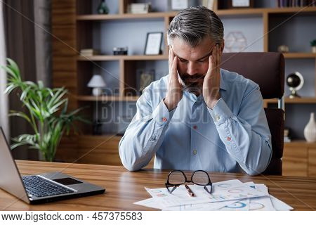 Tired Businessman After Exhausting Paperwork Feeling Eye Strain. Head Ache, Bad Vision, Chronic Fati