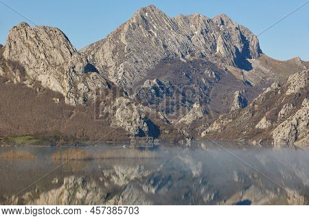 Picturesque Reservoir And Mountain Landscape In Riano. Mirror Effect. Spain