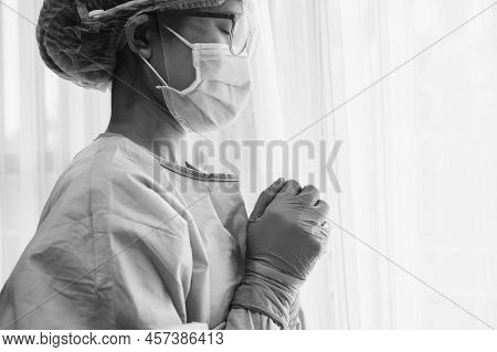 Black And White Tone Of Healthcare Worker Praying For God Blessing While Working In Hospital During 