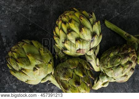 Fresh Artichoke On Black Background. Raw Artichok Closeup