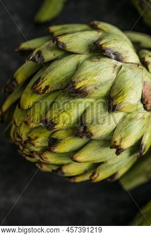 Fresh Artichoke On Black Background. Raw Artichok Closeup