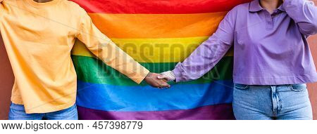 Happy Gay Couple Holding Hands While Celebrating Lgbtq Pride Parade
