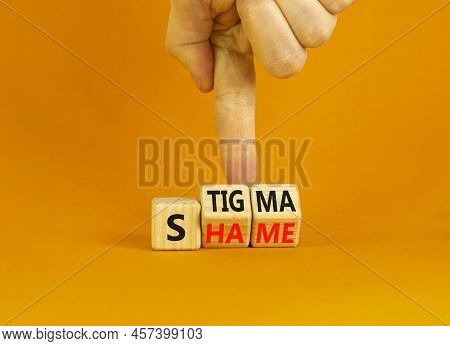 Stigma Or Shame Symbol. Concept Words Stigma Or Shame On Wooden Cubes. Businessman Hand. Beautiful O