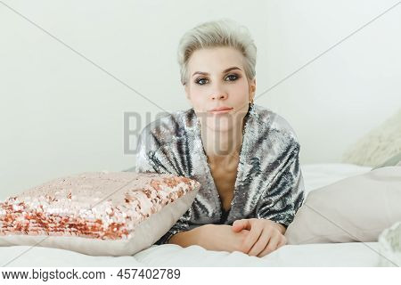 Close Up Portrait Of Attractive Woman With Blonde Pixie Haircut Looking At Camera