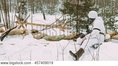 Hidden Re-enactor Dressed As German Wehrmacht Infantry Soldier In World War Ii Soldiers Sitting In A
