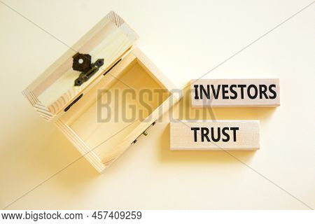Investors Trust Symbol. Concept Words Investors Trust On Wooden Blocks On A Beautiful White Table Wh