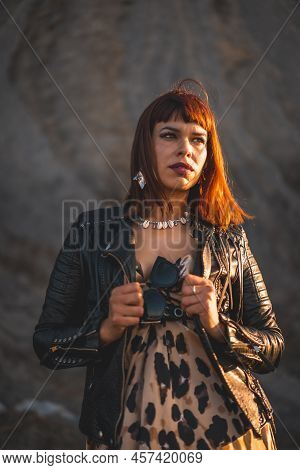 Summer Street Style On A Beach Next To Rocks Of A Young Brunette Caucasian Woman In A Leopard Dress 