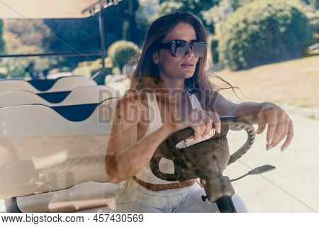 A Middle-aged Woman Is Driving A Car For Transporting Tourists. Electric Car, Tourist Bus. Car For T