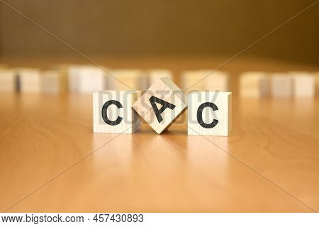 Cac Text On Wooden Blocks, Financial Business Concept, Blue Background. Cac - Short For Customer Acq