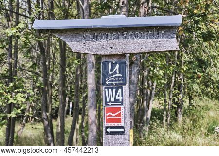 Wooden Sign Of The Hoppecke Quelle, A Popular Destination Of The Rothaarsteig In Sauerland With Trai