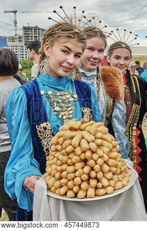 Yekaterinburg, Russia - June 25. 2022: Cute Smiling Asian Girls In National Festive Clothes Holding 