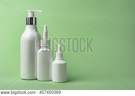 White Cosmetic Tubes On Mint Color Background With Copy Space. Skin Care, Body Care, Beauty Concept.