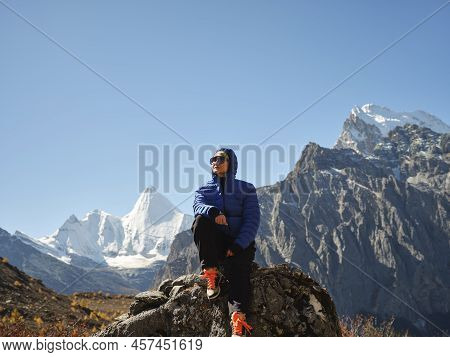Asian Woman Female Traveler Enjoying Nature In Yading National Park In Sichuan Province, China, With