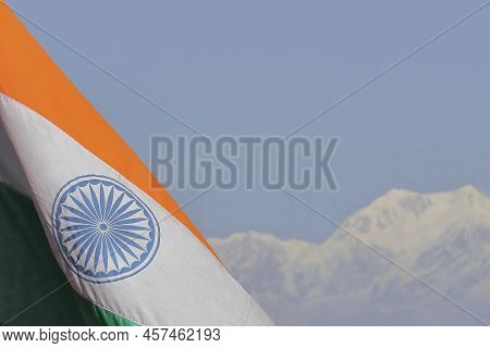 Tri Colour Indian National Flag And Snowcapped Himalaya Mountains With Blue Sky In The Background