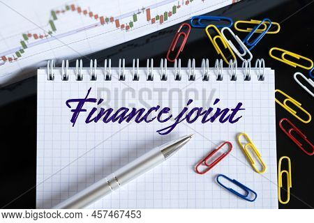 Finance And Economics Concept. On The Desktop Are A Forex Chart, Paper Clips, A Pen And A Notebook I