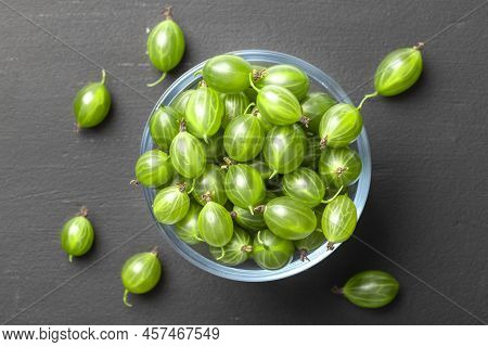 Ripe Green Gooseberries In A Glass Transparent Bowl And Jar On A Black  Background. Harvest Concept 