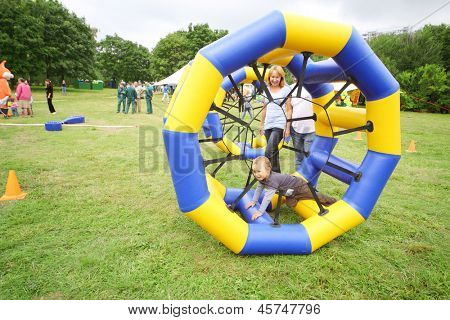 MOSCOW - AUGUST 18: Child crawls in large inflatable wheels at festival Ekofest 2012 on banks of Stroginsky gulf, on August 18, 2012 in Moscow, Russia.