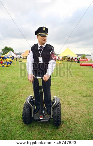 MOSCOW - AUGUST 18: Security guard on Segway at festival Ekofest 2012 on banks of Stroginsky gulf, on August 18, 2012 in Moscow, Russia.