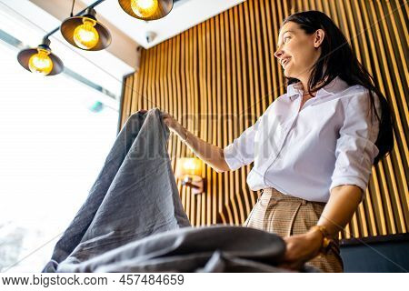 Indian Woman Setting The Table For Dining In Day Light Room