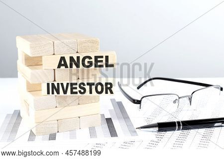 Angel Investor Is Written On A Wooden Blocks On A Chart Background