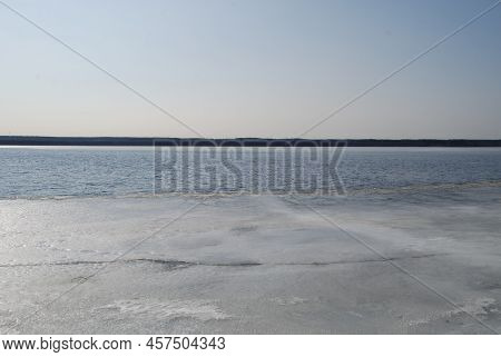 A Wide River Is Being Freed From Ice. Spring Day Light Blue Sky, River Flood With Blue Water. At The