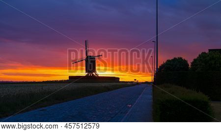 This Beautiful Mountain Mill Is Located In Wannegem-lede Belgium, With The Rise Of The Sun And  Clou