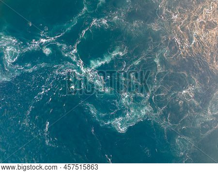 Aerial Topdown View Of Powerful Ocean Current With Sunset Color