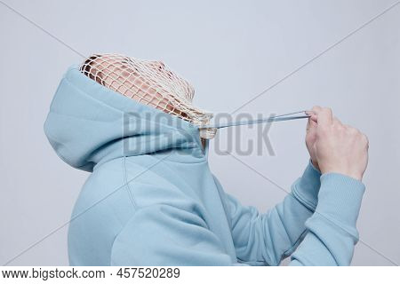 A Tortured Man Suffering From Problems With A Mesh On His Face Stands In A Light Blue Hoodie On A Li