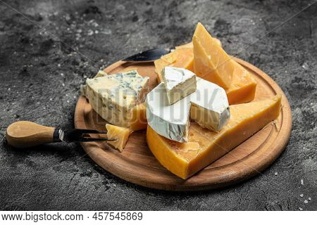 Parmesan. Different Types Of Cheese With Knife On A Dark Background. Cheeses Set Dor Blu Chedar Cama