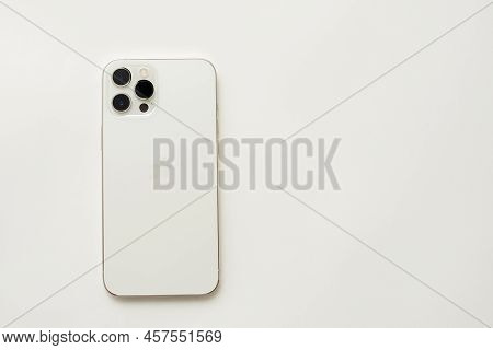 Stariy Oskol, Russia - July 5, 2021: New White Iphone On White Paper Background