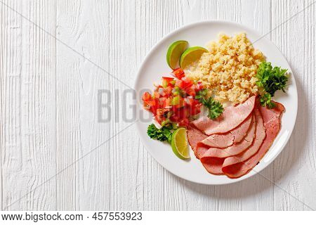 Thinly Sliced Roast Beef Fillet With Quinoa And Tomato Pepper Salsa On White Plate On White Wooden T