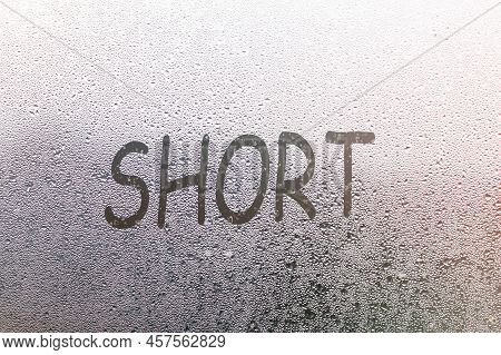 Foggy Glass On Window With Written Finger Word Short
