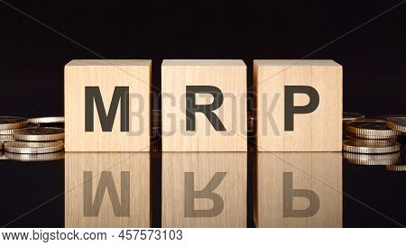 Mrp Text On Wood Cubes With Coins, Black Background, Business Concept. The Inscription On The Cubes 