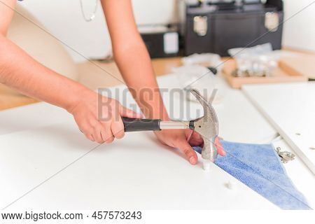 Latin Bolivian Strong And Independent Success Woman Assembly And Repair Furniture With Hammer.
