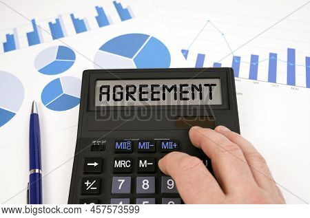 Business Concept. There Is A Calculator On Documents With Graphs And Diagrams. On The Scoreboard Of 