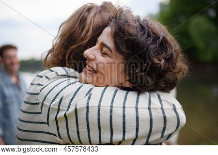 Friends Having Fun Together At Park Lauging And Hugging, Friendship And Lifestyle Concepts