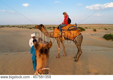 Thar Desert,rajasthan,india-15th October 2019 : Cameleer Leading A Female Tourist Into The Desrt, Ca