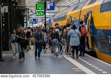 Amsterdam, The Netherlands - 21 June 2022: People Boarding Nederlandse Spoorwegen Train In Amsterdam