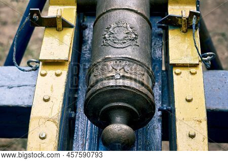 Vintage Swedish Cannons And Metal Cannonballs. Ancient Military Arsenal Of The Events Of The Russian