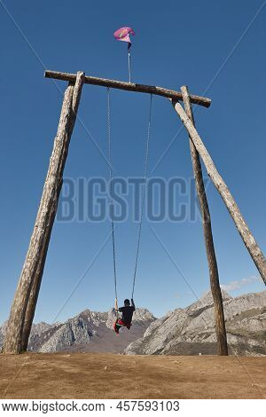Huge Swing Surrounded By Mountains In Riano Village. Spain