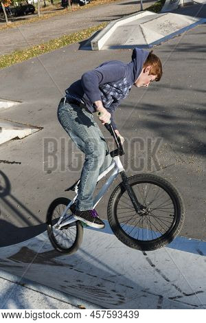 Eschborn, Germany - October 12, 2009: Joung Red Haired Boy Is Jumping With His Bmx Bike At The Skate