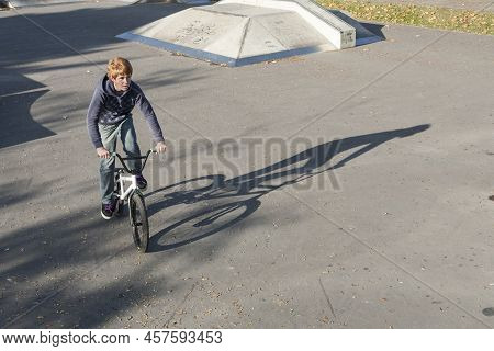 Eschborn, Germany - October 12, 2009: Joung Red Haired Boy Is Jumping With His Bmx Bike At The Skate