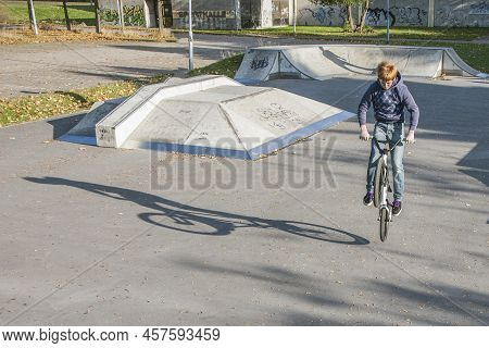 Eschborn, Germany - October 12, 2009: Joung Red Haired Boy Is Jumping With His Bmx Bike At The Skate