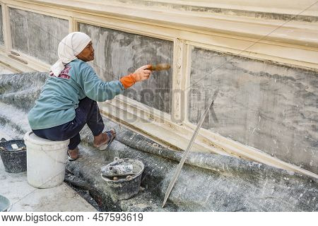 Bangkok, Thailand - January 4, 2010: Woman Renovates A Wall Iof A Temple In The Inner Grand Palace O