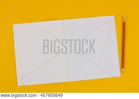 School Notebook On A Yellow Background With Copy Space For Text, Colorful Markers, English Alphabet.
