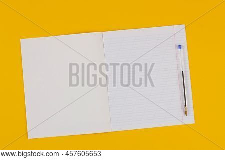 School Notebook On A Yellow Background With Copy Space For Text, Colorful Markers, English Alphabet.