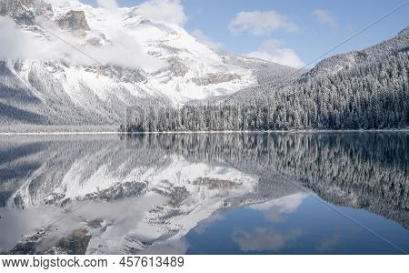 Still Alpine Lake Reflecting Its Winter Surroundings Like A Mirror, Yoho N. Park, Canada.