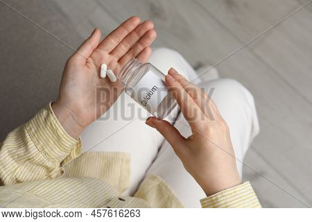 Calcium Supplement. Woman Taking Pills Indoors, Top View