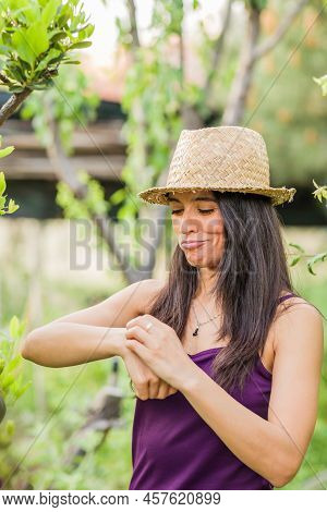 Pain For Mosquito Or Sting Bite Allergic. Hispanic Mid Woman Healthy Skin In Nature Garden