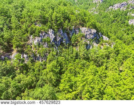 High Mountains Of Stone And Sand In A Hot, Tropical Country. Mountain With Green Bushes And Herbs. P
